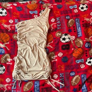 This is a tan, ribbed, off the shoulder, mini dress from VonMaur.